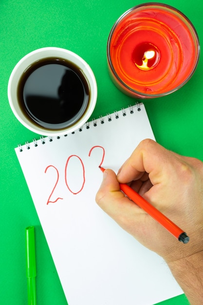 A close-up of a calendar marking important dates for HSA contributions in 2025, along with a pen and notebook.