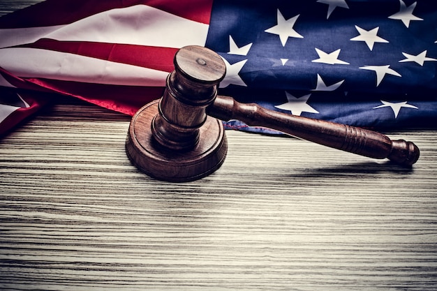 A gavel hitting a sound block, with the American flag in the background, symbolizing the Federal Reserve's decision-making process regarding interest rates.