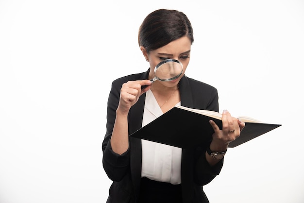 An image of a person reviewing tax documents with a magnifying glass, symbolizing the act of carefully examining deductions and credits. Key takeaway is the importance of due diligence in tax preparation.