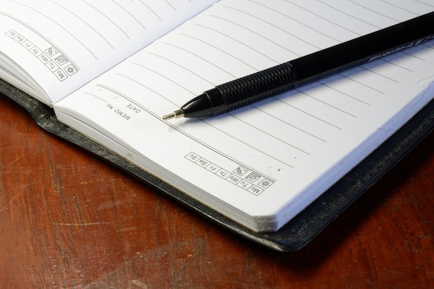 A close-up of a FAFSA application form being filled out with a pen. The form is on a desk with a calculator and various financial documents scattered around, symbolizing the complexities of financial aid applications.