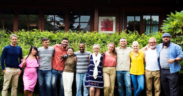 A medium shot showing a group of diverse community members gathered around a newly installed charging station for electric vehicles. The background includes a park with trees and benches, representing the integration of green technology and community spaces.